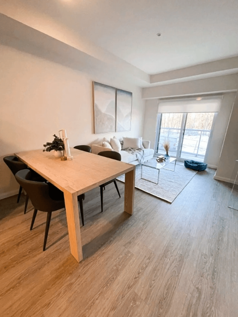 an open living room and dining room with a wooden table